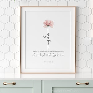 以下が含まれることがあります： ピンクの花と「SHE IS CLOTHED WITH STRENGTH AND DIGNITY; she can laugh at the days to come. PROVERBS 31:25」というテキストが書かれた、印刷可能な壁の芸術デザイン