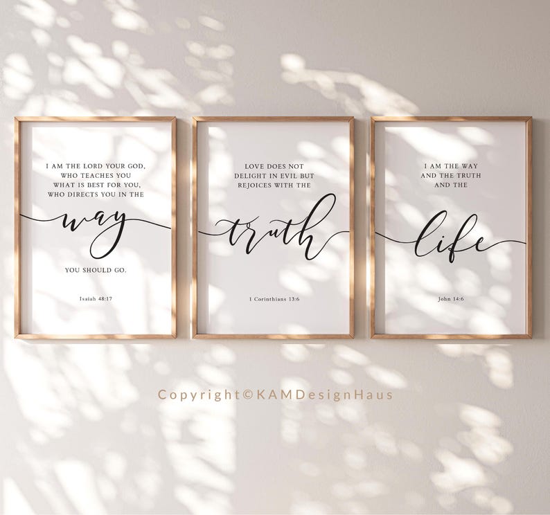 May include: Three framed art prints with inspirational quotes in black script on white backgrounds. The frames are a light wood colour. The quotes are about the way, truth, and life. The copyright is visible at the bottom.