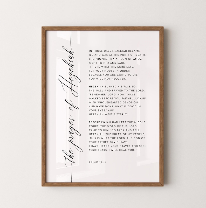 May include: A framed print with the text "the prayer of Hezekiah" in elegant script. The print features a passage from 2 Kings 20:1-5, set against a white background, encased in a wooden frame.