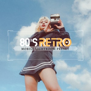 May include: A woman wearing a black and white striped skirt and a black jacket holds a vintage camera in front of a blue sky with white clouds. The text "80's RETRO MOBILE LIGHTROOM PRESET" is displayed in a white box with a yellow border.
