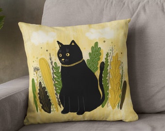 May include: A black cat with yellow eyes sits in a field of green and yellow plants on a yellow background. The cat is wearing a gold collar.