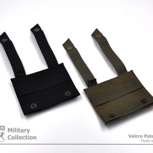 Peut inclure: Deux panneaux de patchs velcro noirs et verts avec des sangles. Les panneaux ont plusieurs rang&eacute;es de coutures et sont con&ccedil;us pour &ecirc;tre fix&eacute;s aux v&ecirc;tements ou &agrave; l'&eacute;quipement. Le texte "Velcro Patch Panel Made with Passion" est imprim&eacute; dans le coin inf&eacute;rieur droit de l'image.