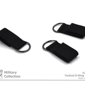 Pode incluir: Tr&ecirc;s adaptadores t&aacute;ticos em D pretos com uma correia de nylon preta. Cole&ccedil;&atilde;o Militar. Cor preta. Adaptador t&aacute;ctico em D. Feito com paix&atilde;o.
