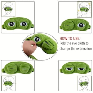 Puede incluir: M&aacute;scara de ojos de felpa verde con forma de rana y ojos grandes y expresivos. La m&aacute;scara tiene una textura suave y est&aacute; dise&ntilde;ada para cubrir los ojos. El texto de la imagen dice "HOW TO USE: Fold the eye cloth to change the expression."