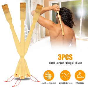 May include: Three wooden back scratchers with red strings attached to the bottom. The scratchers are made of bamboo and have smooth edges. The text "3PCS Total Length Range: 18.3in" is displayed below the scratchers.  The icons for bamboo material, smooth edges, and massage are displayed below the text.