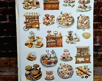 May include: A sheet of stickers featuring various bakery and pastry illustrations. The stickers depict items like cupcakes, pies, donuts, and bread, along with bakery carts and display cases. The text "Plans Creatively" and a website address are visible.