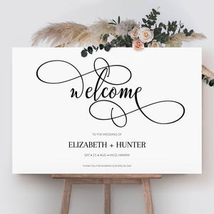 May include: A white welcome sign with black calligraphy for a wedding. The sign reads "Welcome to the wedding of Elizabeth + Hunter, Sat 21 Aug. Hilo Hawaii. Thank you for sharing our special day."