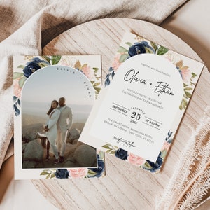 May include: Wedding invitation featuring a floral design in shades of pink, blue, and green. The invitation includes a photograph of a couple in a scenic landscape. The text reads "Olivia + Ethan" and includes the date and time of the wedding ceremony. The invitation also includes the location of the ceremony and reception.