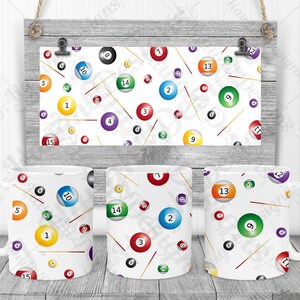 May include: Three white ceramic mugs featuring a pattern of billiard balls and cues. The balls are numbered 1 to 15 and are in various colours. The mugs are on a wooden surface.