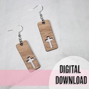 May include: A pair of wooden earrings with a cross cut-out design. The earrings are a light brown color and have silver hooks.