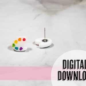May include: A pair of white paint palette earrings with rainbow colored paint dots. The earrings are shown on a white marble surface. DIGITAL DOWNLOAD text is visible in the image.