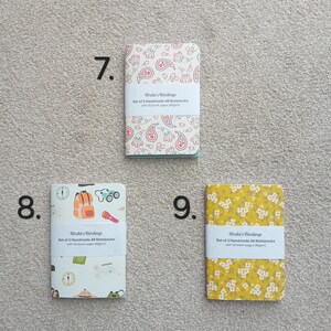 May include: Set of two A6 notebooks with paisley, floral, and camping themed covers. Each notebook has 30 blank pages. The notebooks are from Birdie's Bindings.