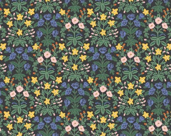 May include: A repeating floral pattern featuring stylized flowers in yellow, pink, and blue against a dark gray background. The design includes detailed green leaves and small orange accents, creating a symmetrical and ornate look. This pattern is suitable for fabric or wallpaper.