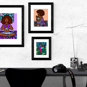 May include: Three framed illustrations of women in different yoga poses. The illustrations are colorful and feature a black background. The frames are black and have a white mat.