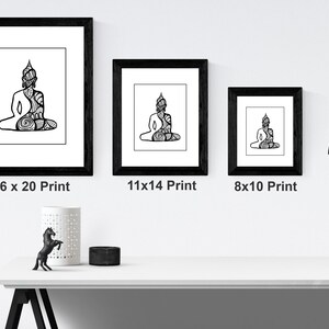 May include: Three black framed prints of a line drawing of a meditating Buddha. The prints are in different sizes: 16x20, 11x14, and 8x10 inches.