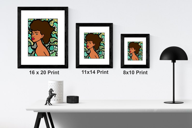 May include: Three framed prints of a colorful illustration of a woman with an afro hairstyle. The prints are in black frames and are displayed on a white shelf. The prints are labeled with their dimensions: 16 x 20, 11 x 14, and 8 x 10.
