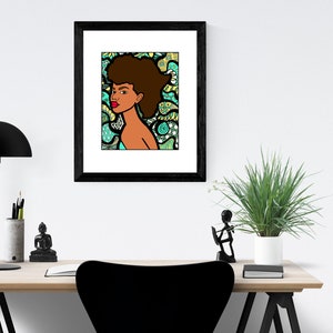 May include: A framed illustration of a woman with an afro hairstyle. The woman is looking to the right and has a red lip. The background is a colorful abstract pattern in shades of green, blue, and yellow.