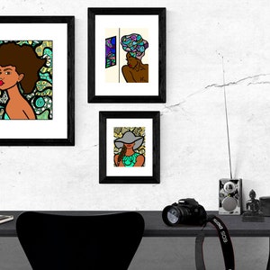 May include: Three framed illustrations of women with different hairstyles and headwear. The illustrations are in a black frame and are hung on a white wall. The illustrations are in a colorful cartoon style.