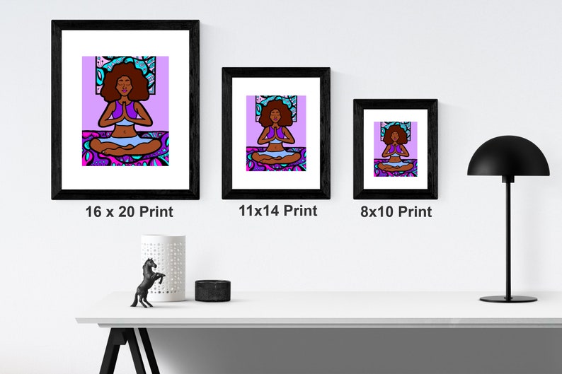 May include: Three framed prints of a digital illustration of a woman meditating in a lotus pose. The woman has dark skin, brown hair, and is wearing a purple top and blue pants. The background is a purple and blue mandala pattern. The prints are in black frames and are labeled with their dimensions: 16 x 20, 11 x 14, and 8 x 10.