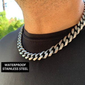 May include: A silver curb chain necklace made of waterproof stainless steel.