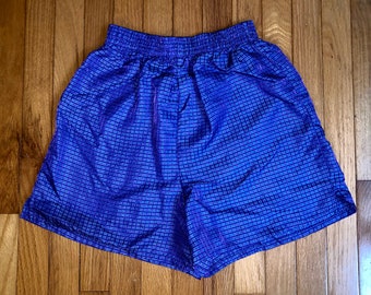 Puede incluir: Shorts de cuadros azules y morados con cintura elástica.