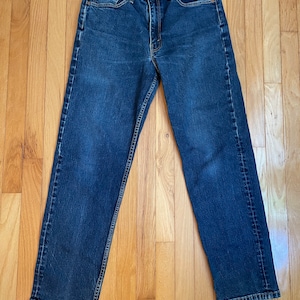 May include: A pair of dark blue denim jeans with a classic straight leg fit.