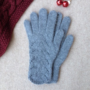 May include: A pair of gray knitted gloves with a delicate lace pattern. The gloves are made of a soft, warm material and are perfect for keeping your hands warm in the winter.
