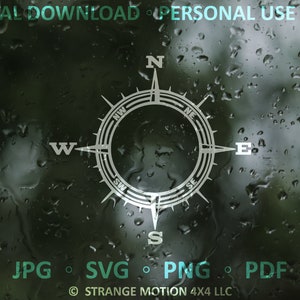 May include: A white compass with a black outline and a black circle in the center. The compass is on a blurry background of water droplets on a window. The compass points are labeled N, S, E, W, NE, NW, SE, and SW. The text "DIGITAL DOWNLOAD PERSONAL USE ONLY" is at the top of the image. The text "JPG SVG PNG PDF" is at the bottom of the image. The text "STRANGE MOTION 4X4 LLC" is at the bottom of the image.