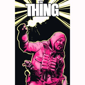 May include: A pink and black graphic illustration with the text "THE THING". The image shows a person in a hooded jacket, holding a weapon and a raised fist, with a burst of light emanating from the fist.