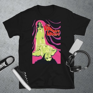 May include: Black t-shirt with a vintage movie poster design featuring a woman in a white dress and the text "The Vampire Lovers".
