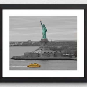 May include: A black and white photograph of the Statue of Liberty with a yellow ferry boat in the foreground.