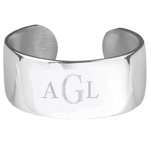 May include: A silver cuff bracelet with the initials "AGL" engraved on the front.