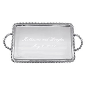May include: A rectangular silver serving tray with beaded edges and handles. The tray is engraved with the names "Katherine and Douglas" and the date "May 9, 2021".