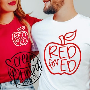 May include: Two white t-shirts with a red apple graphic and the text "RED for ED" printed on them.