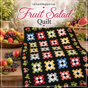 May include: A black quilt featuring a repeating pattern of colourful, multi-coloured square blocks arranged in a grid. The border is decorated with printed illustrations of various fruits, including cherries, pears, and apples. Text reads Fruit Salad Quilt.