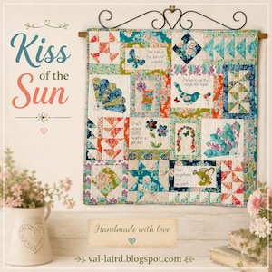 May include: A square patchwork quilt featuring floral patterns in teal, coral, and green. The quilt displays various blocks with illustrations of butterflies, birds, flowers, and fans, alongside text segments reading Kiss of the Sun and poetry.