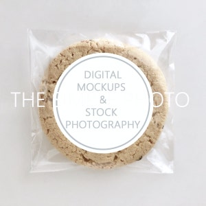 May include: A single cookie in a clear plastic bag with a white circle label that says "DIGITAL MOCKUPS & STOCK PHOTOGRAPHY".
