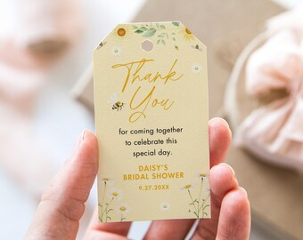 May include: Yellow thank you tag with a floral design featuring daisies and bees. The text reads "Thank You" for coming together to celebrate this special day. Daisy's Bridal Shower 9.27.20XX.
