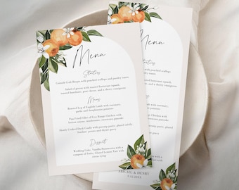 May include: Elegant wedding menu cards with a floral and citrus design. The cards feature the word "Menu" at the top, with menu items listed below. The design includes orange illustrations and the names "Abigail & Henry" with a date.