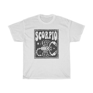 May include: White t-shirt with a black and white graphic of a scorpion and the word "SCORPIO" in a retro font.