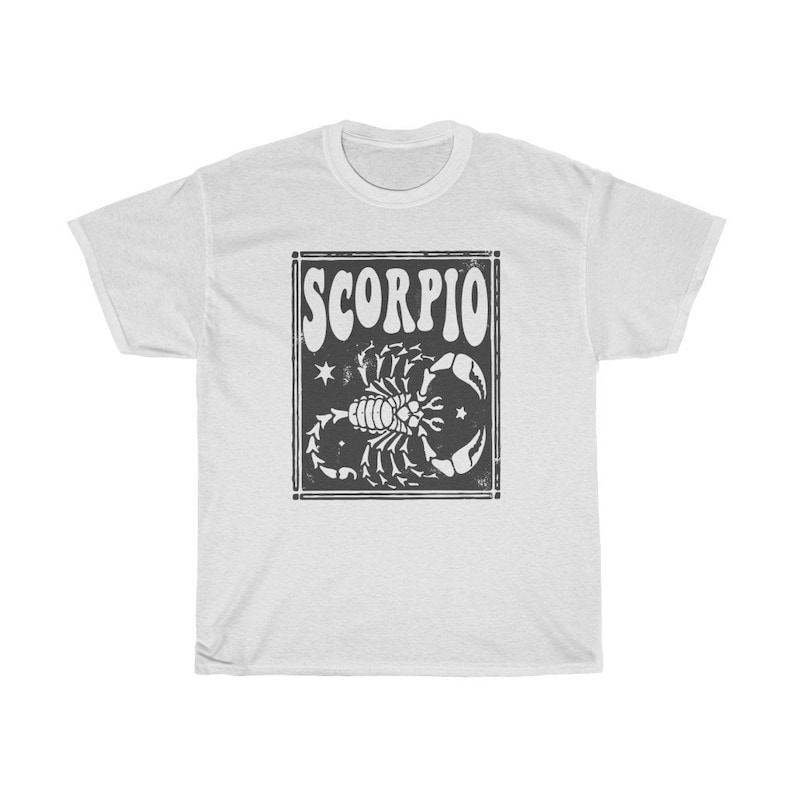 May include: White t-shirt with a black and white graphic of a scorpion and the word "SCORPIO" in a retro font.
