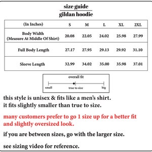 May include: Size chart for a Gildan hoodie in inches. The chart shows the body width, full body length, and sleeve length for sizes S, M, L, XL, and 2XL. The chart also includes a note that the style is unisex and fits like a men's shirt, but fits slightly smaller than true to size. It recommends going up one size for a better fit and a slightly oversized look.