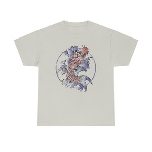 May include: A light grey t-shirt with a circular design featuring a red and blue koi fish swimming in a circle of blue waves.