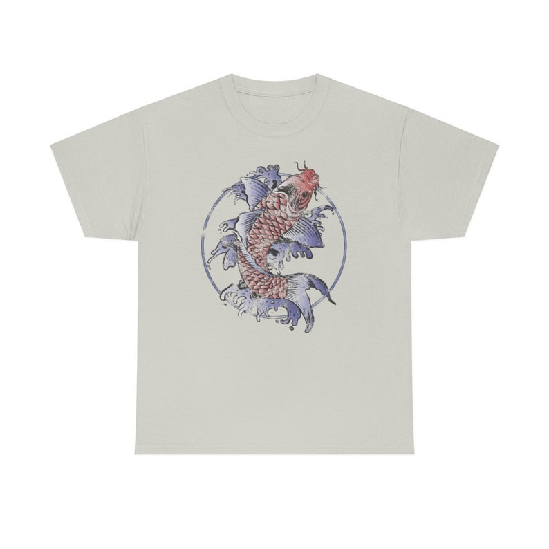 May include: A light grey t-shirt with a circular design featuring a red and blue koi fish swimming in a circle of blue waves.