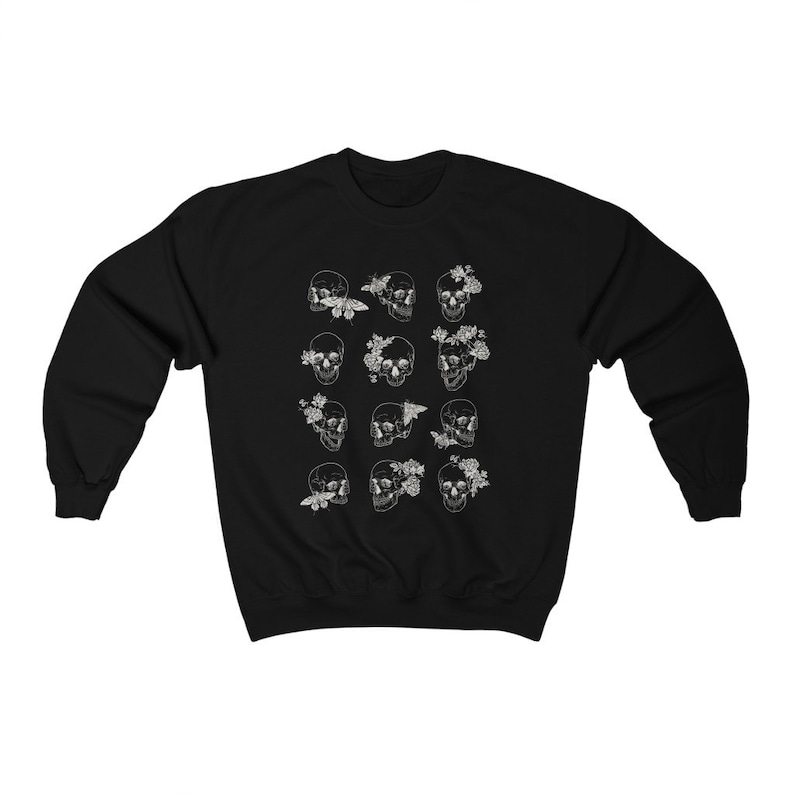 K&ouml;nnte beinhalten: Schwarzer Pullover mit einem wei&szlig;en Druck von mehreren Sch&auml;deln mit Blumen und Schmetterlingen.