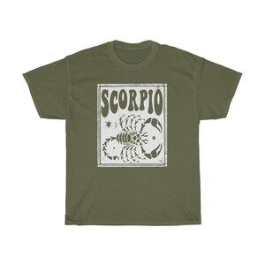 May include: A green t-shirt with a white graphic of a scorpion and the word "SCORPIO" in a retro font.