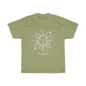 May include: A light green t-shirt with a white sun and stars graphic and the text "LE SOLEIL" printed on the front.