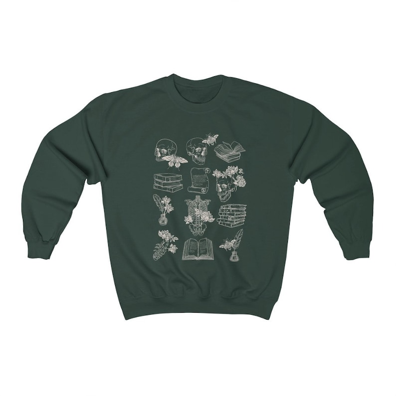 May include: A dark green sweatshirt with a white design of various anatomical illustrations, including a skull, a skeleton, flowers, and books. The design is reminiscent of vintage medical illustrations.