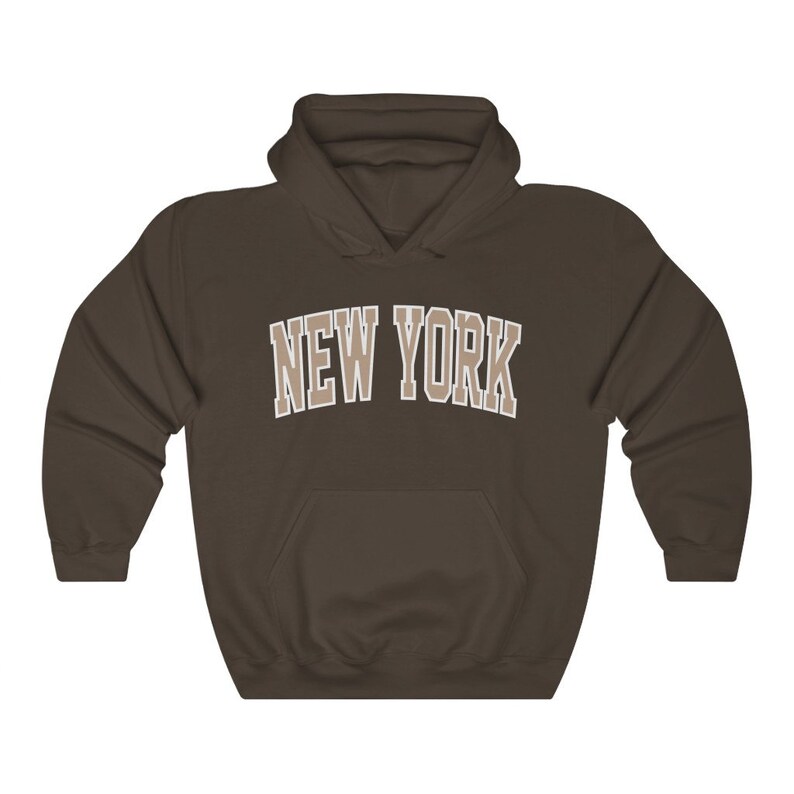 May include: A brown hooded sweatshirt with the text "NEW YORK" in a beige color on the front.