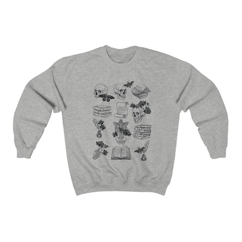 May include: A gray sweatshirt with a black and white illustration of skulls, books, flowers, and other objects. The illustration is centered on the sweatshirt.